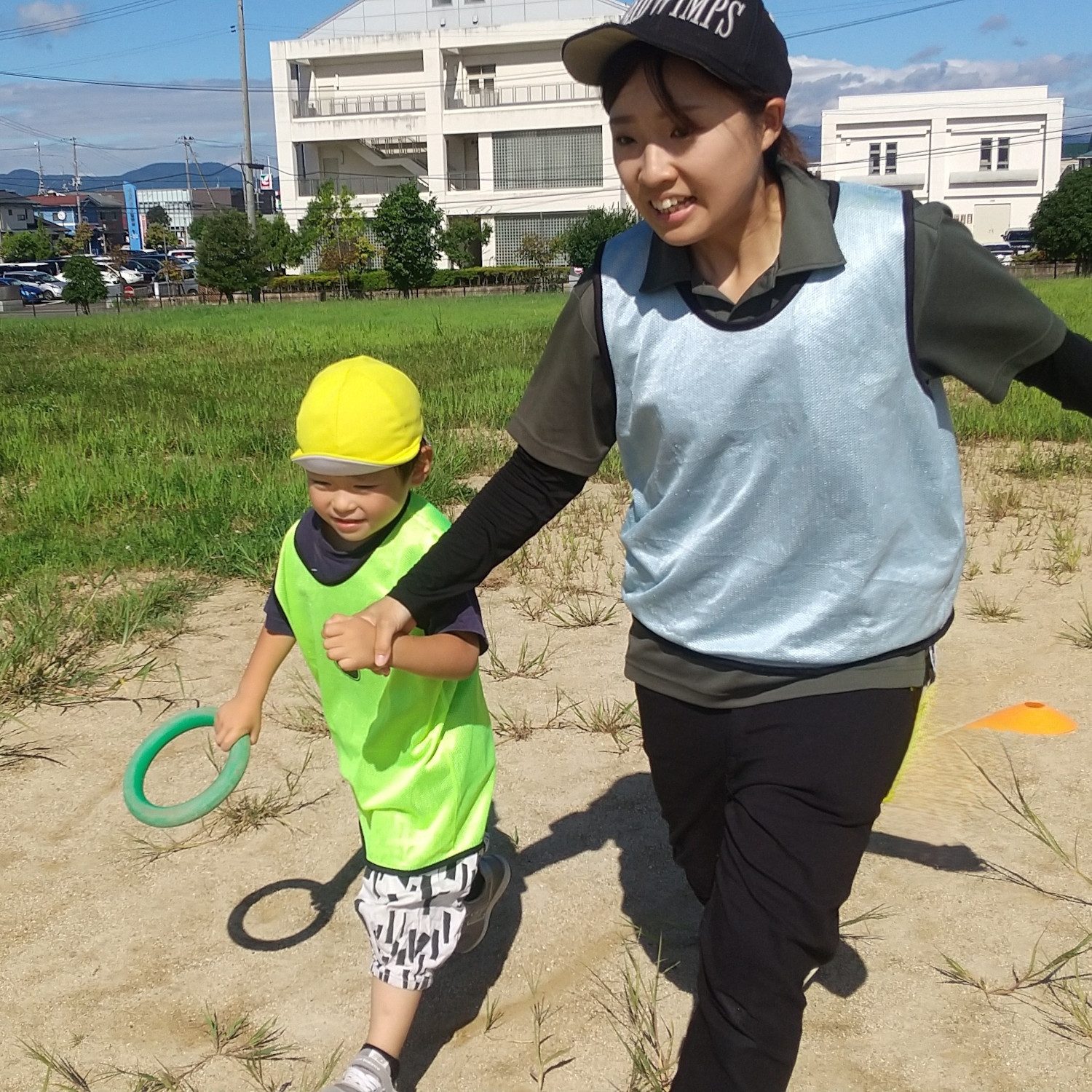 スタッフと一緒にリレーで走る子ども