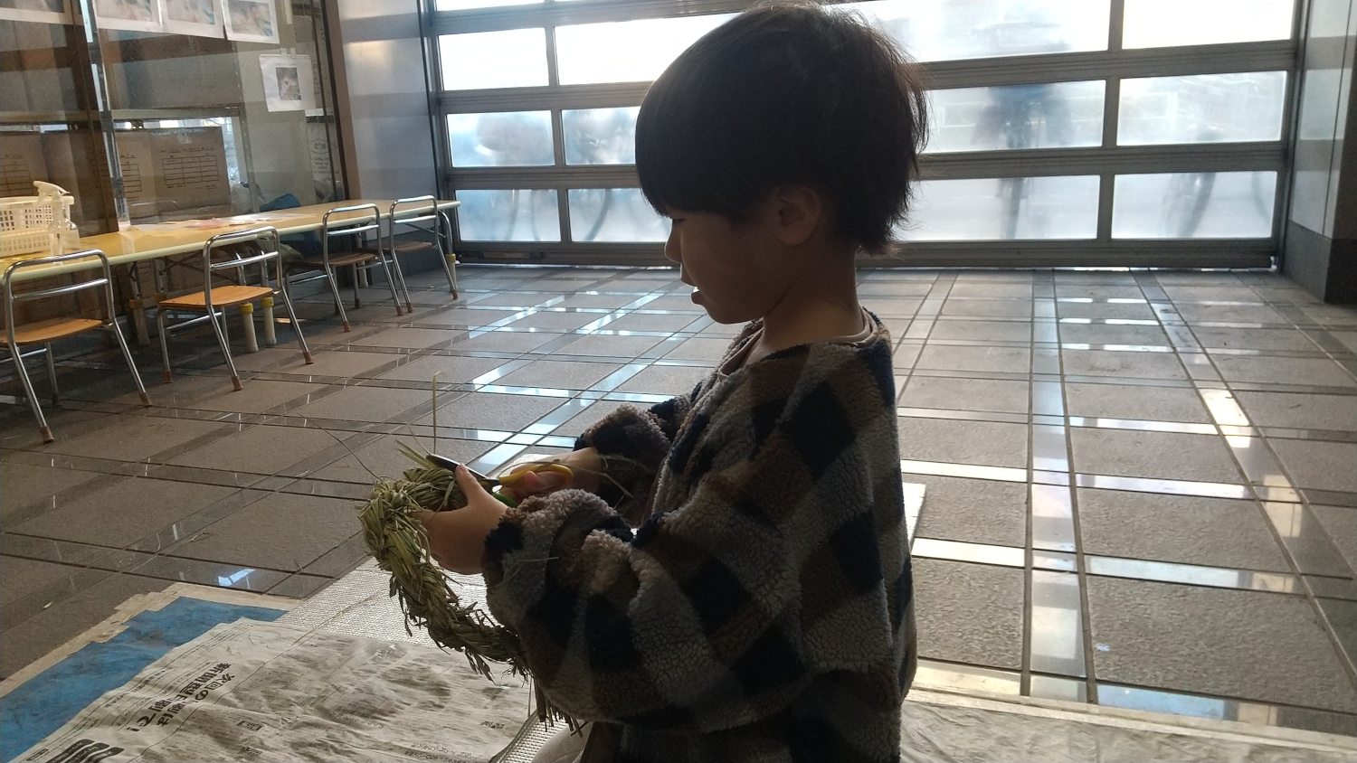 はさみでしめ縄を整える子ども