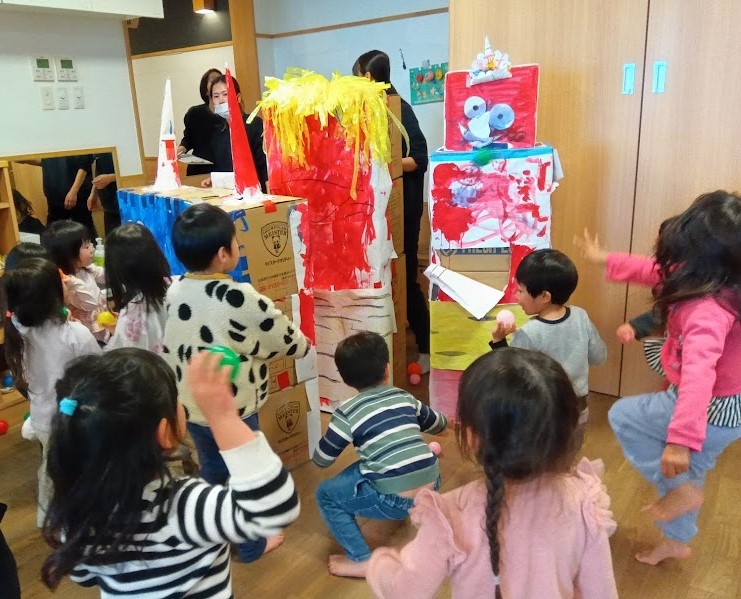 カラーボールを鬼に向かって投げる子どもたち